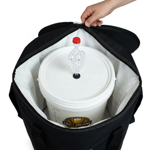 A black and white insulated carrying bag with a silver metal pot inside, shown on a white background with a hand holding the top edge.